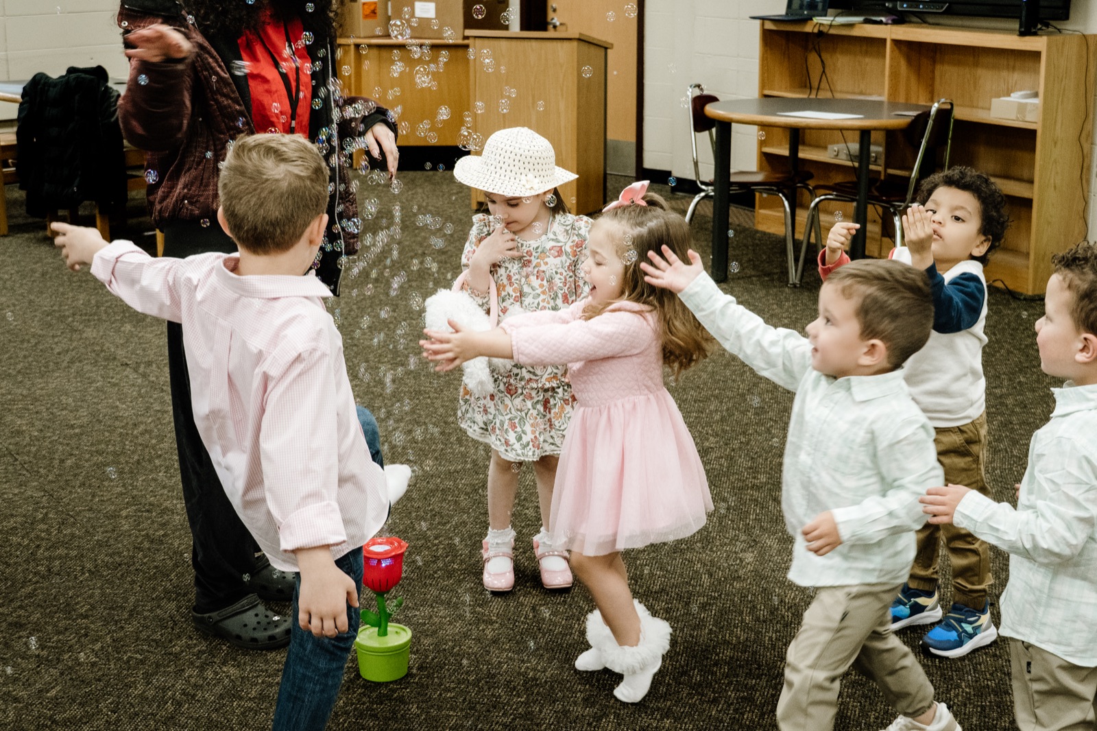 Children laughing and playing with bubbles at CRWC Kidz