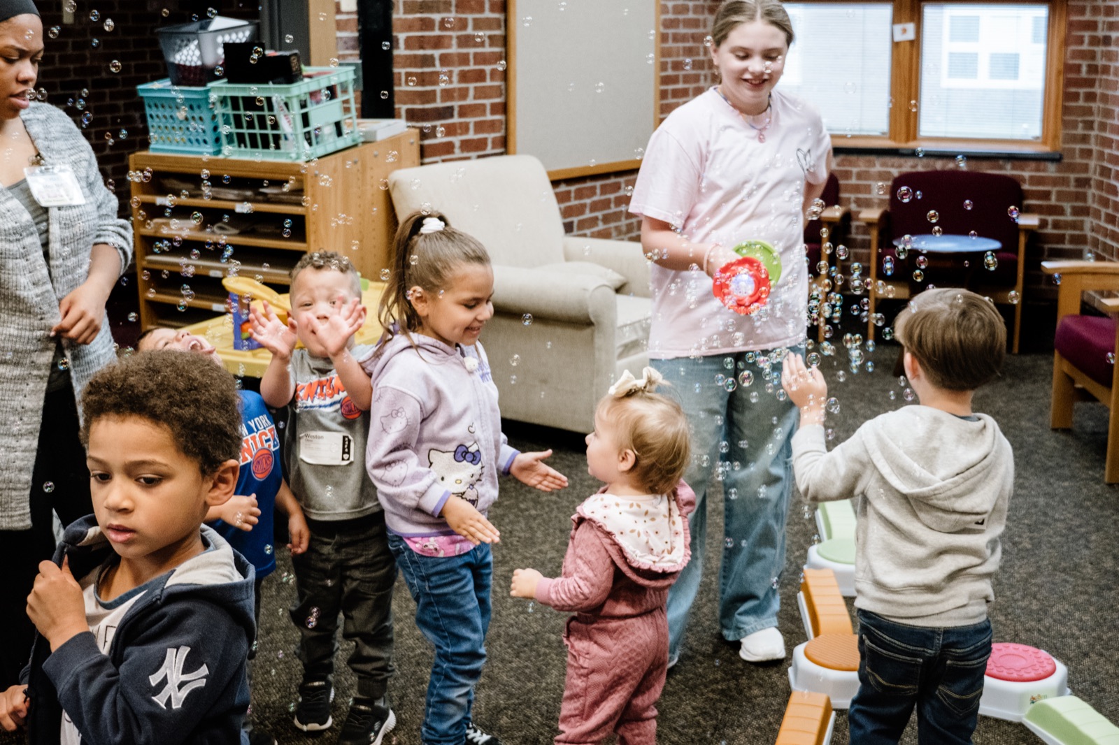 Children joyfully playing with bubbles alongside CRWC Kidz leaders