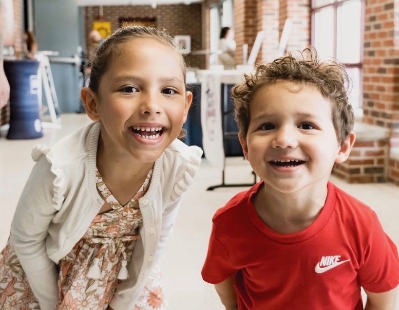 Two children smiling together at CRWC Kidz